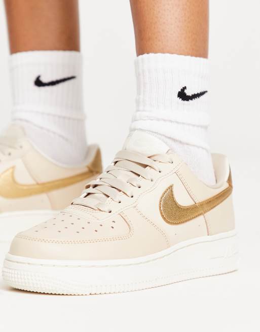 Nike AF1 07 trainers in pink and gold metallic