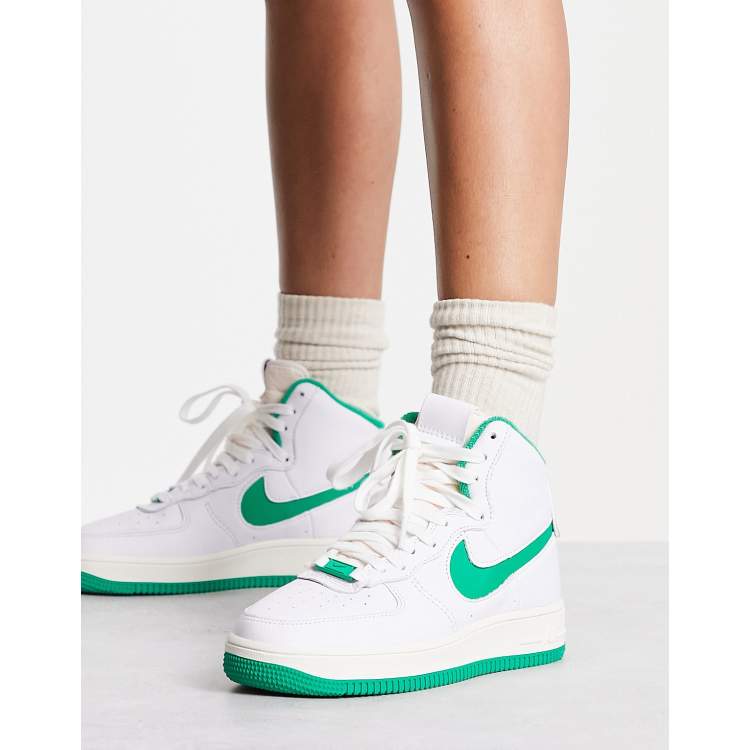 White nikes with store green swoosh