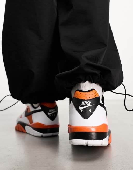 Nike Air Cross Low Sneakers in White & Orange