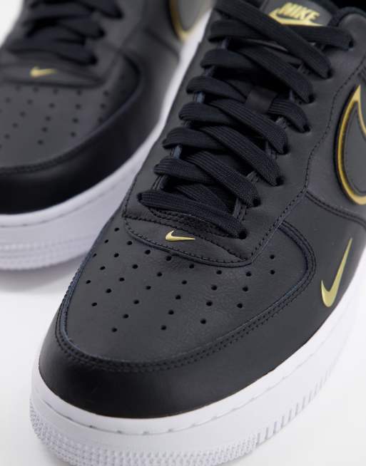 Nike Air Force 1 07 LV8 trainers in black and gold