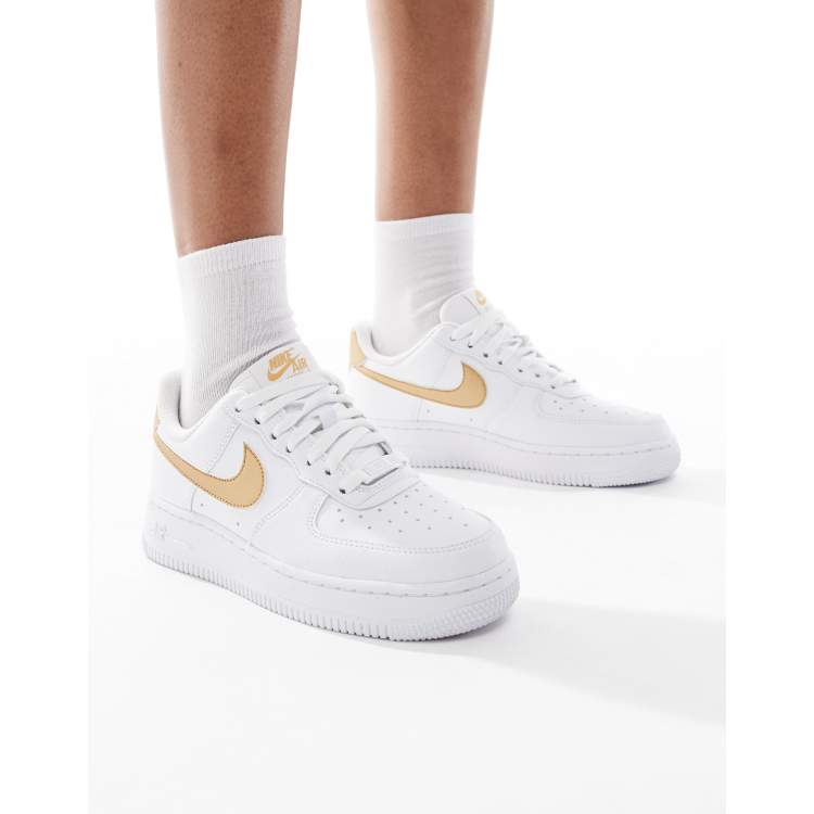 Nike Air Force 1 '07 sneakers in white and gold | ASOS