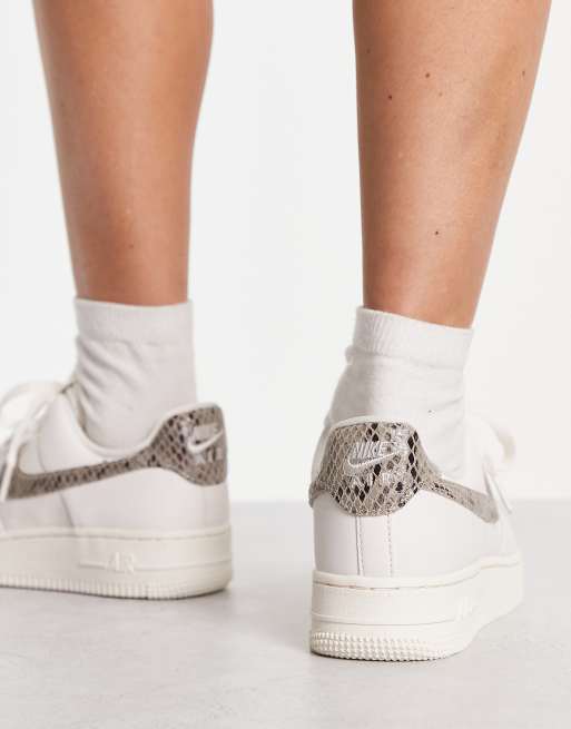 Nike Air Force 1 07 trainers in white and snake print ASOS