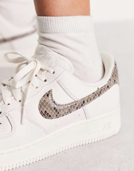 Nike Air Force 1 07 trainers in white and snake print ASOS