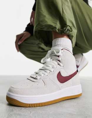 white air forces with red and blue nike sign