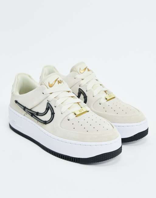 Nike Air Force 1 Sage sneakers with metal stitched in swoosh