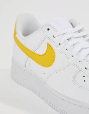 white nike air force with yellow tick