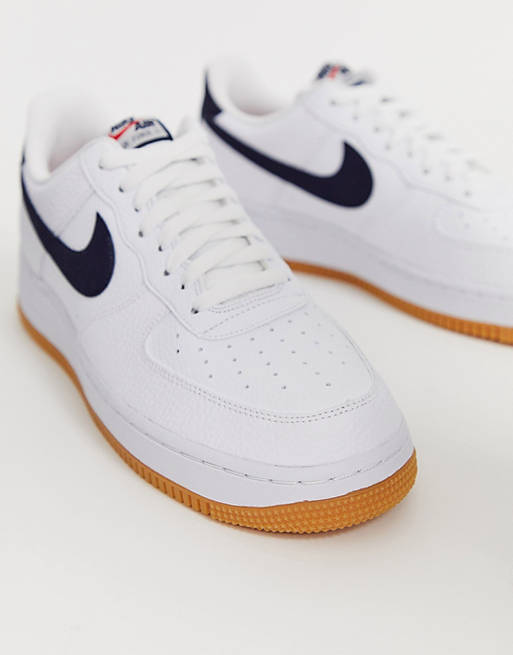 Nike Air Force 1 sneakers with navy swoosh and gum sole