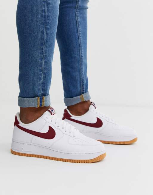 Nike Air Force 1 sneakers with red Swoosh and gum sole