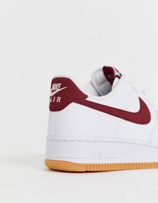 nike air force 1 trainers with red swoosh and gum sole