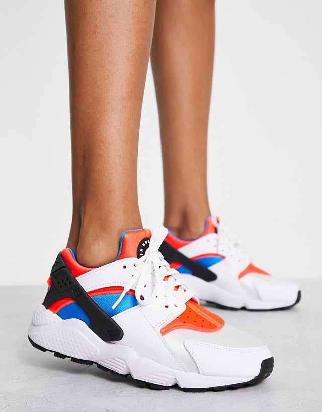 Nike Air Huarache sneakers in white and orange