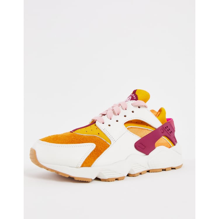 Nike Air Huarache trainers in sail cream and orange ASOS