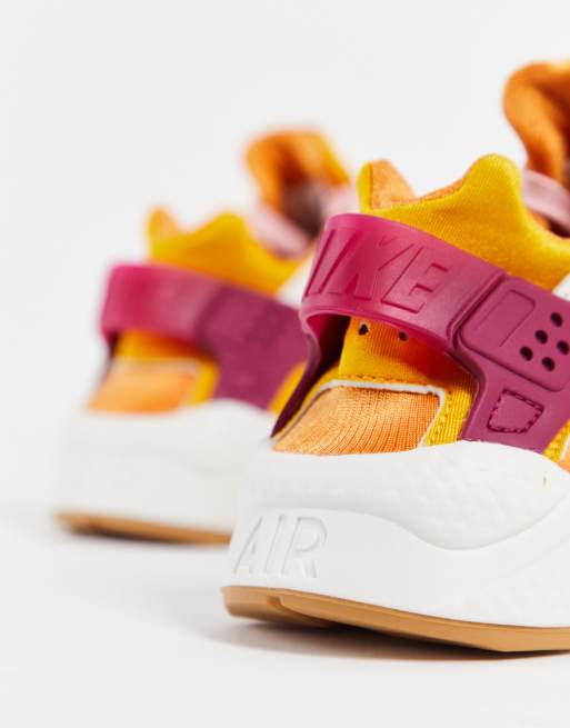 Nike Air Huarache trainers in sail cream and orange