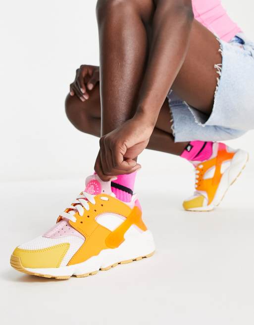 Nike Air Huarache trainers in white and hype pink solar mix