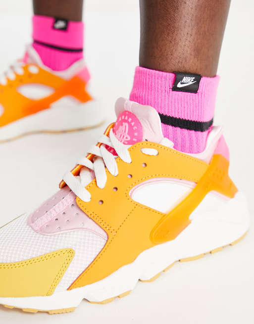 Nike Air Huarache trainers in white and hype pink solar mix