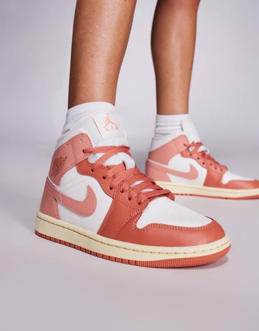 Nike Air Jordan 1 Mid trainers in white and pink
