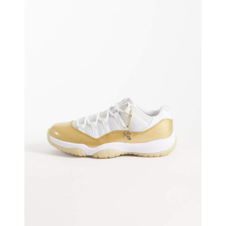 Nike Air Jordan 11 Retro Low sneakers in white and gold | ASOS display picture 1