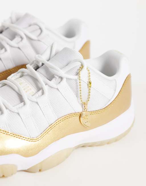 Nike Air Jordan 11 Retro Low sneakers in white and gold | ASOS