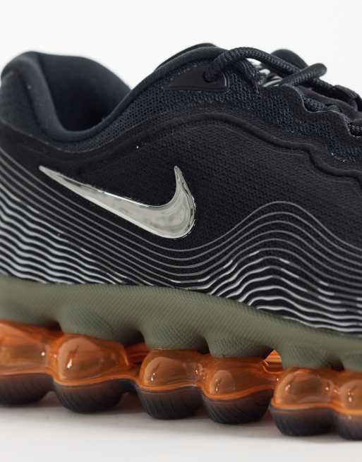 Nike Air Liquid Max trainers in black and orange, 2 of 5