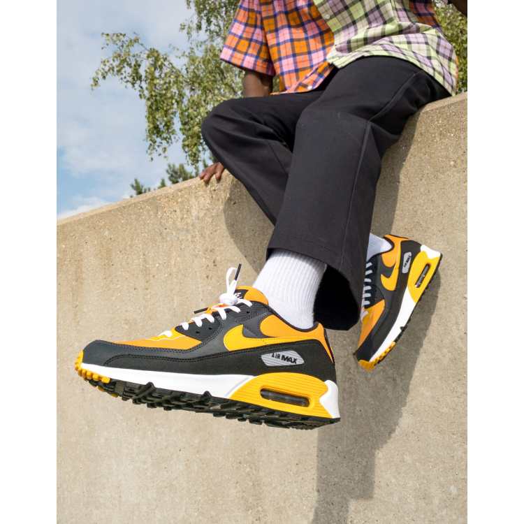 Nike Air Max 90 trainers in university gold and black