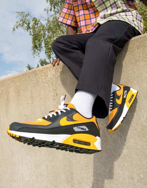 Nike Air Max 90 trainers in university gold and black