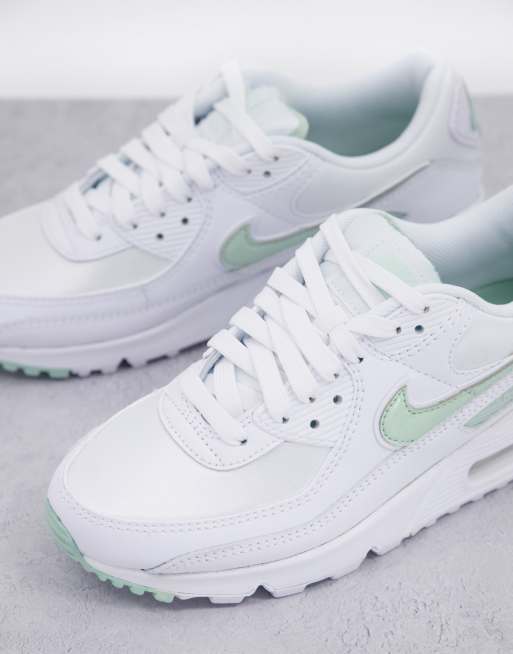 Green and store white nike trainers