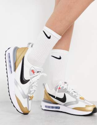 white and gold nike air shoes