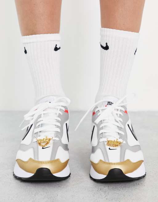 Nike gold 2024 and silver shoes