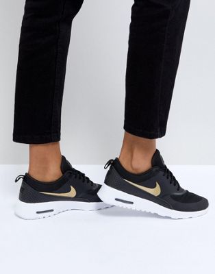 nike air max thea trainers in black and gold