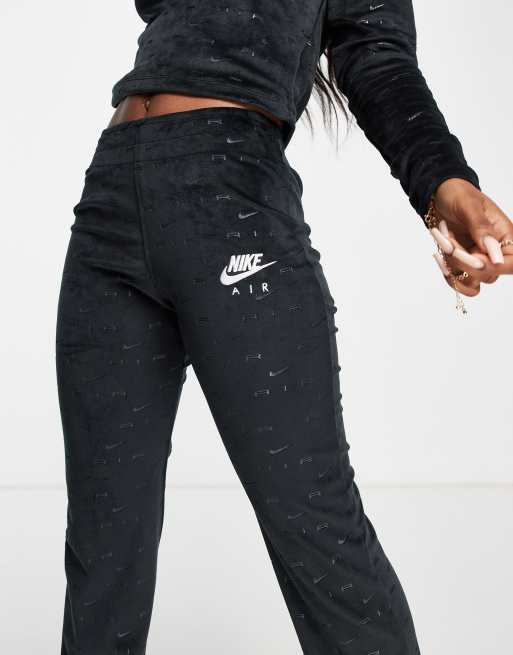 Nike Air velour flare trousers in black with all over swoosh ASOS