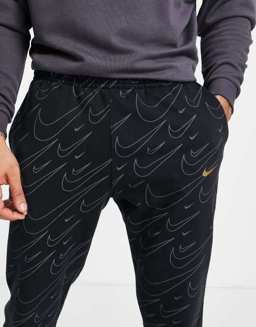 Nike sweatpants with swoosh all over new arrivals