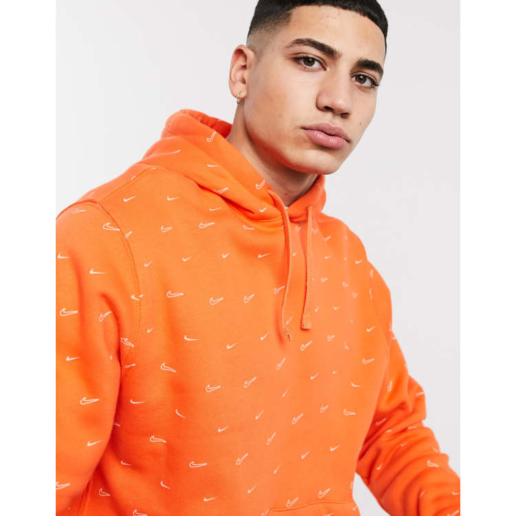 Nike All over swoosh print hoodie in orange ASOS