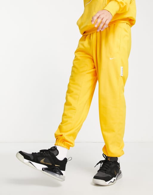 Nike Basketball Dri FIT Standard Issue cuffed sweatpants in yellow YELLOW