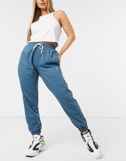 Nike Basketball standard issue fly logo joggers in blue