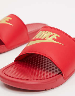 red and gold nike flip flops