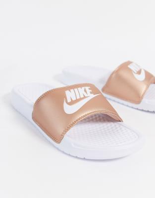 white and rose gold nike slides