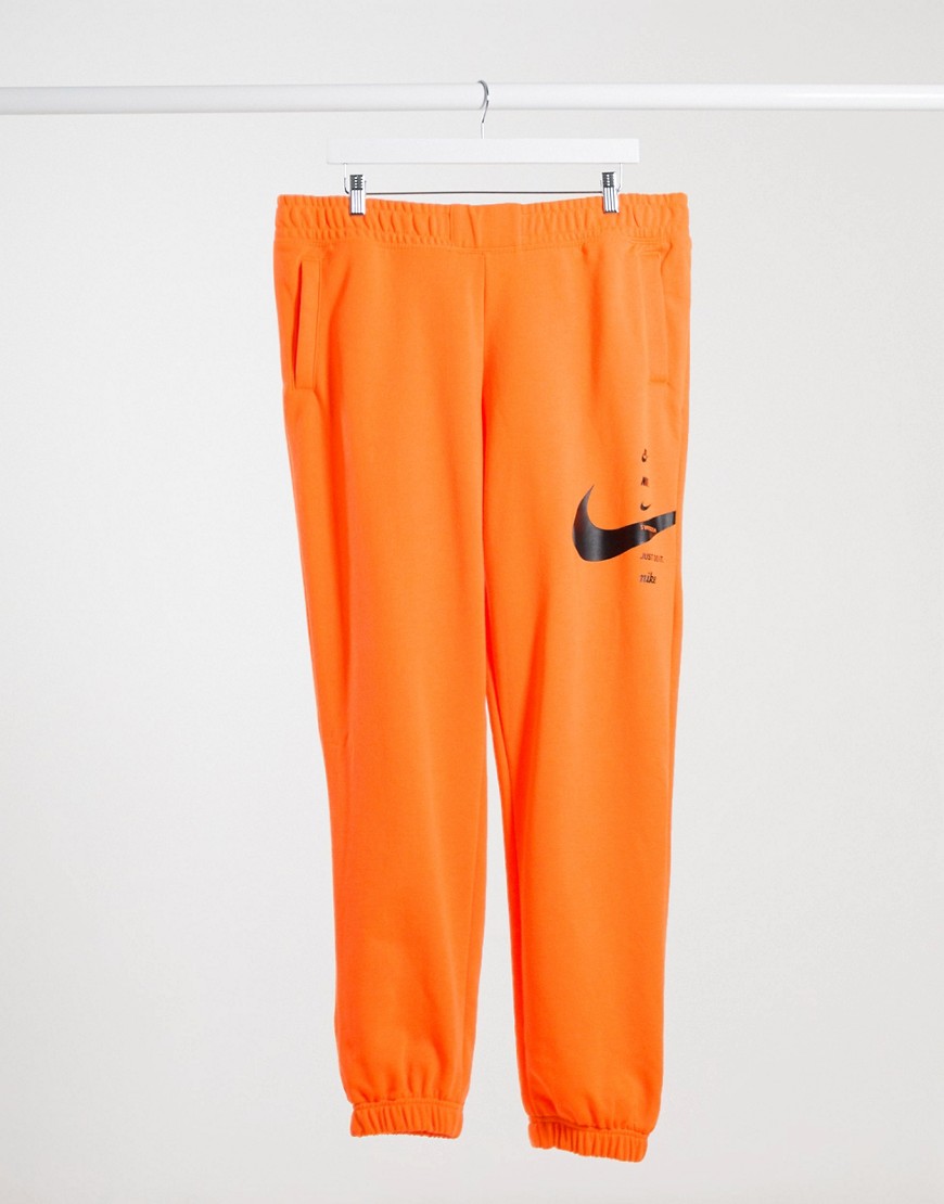 Nike - Broek van fleece met swoosh in oranje en zwart