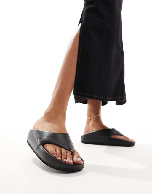 Nike Calm flip flops in black ASOS