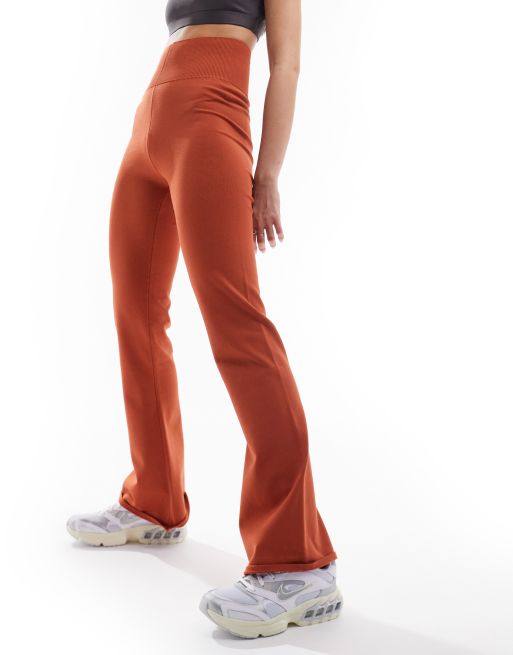 Nike Chill Knit flared pants in burnt orange ASOS