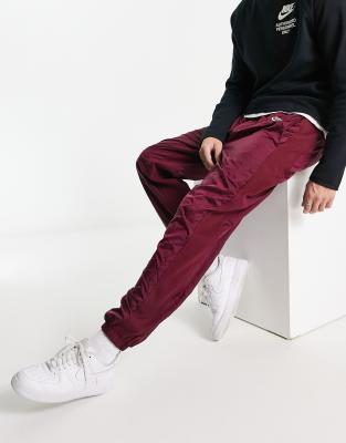 Nike Circa Premium winter textured casual trousers dark beetroot red - ASOS Price Checker
