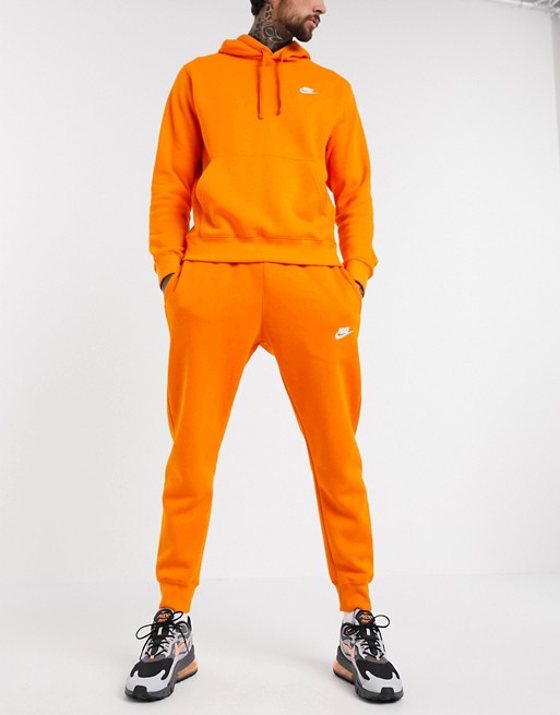 Nike Club cuffed joggers in orange