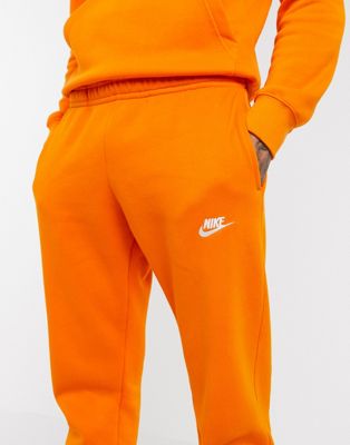 Nike Club cuffed sweatpants in orange 