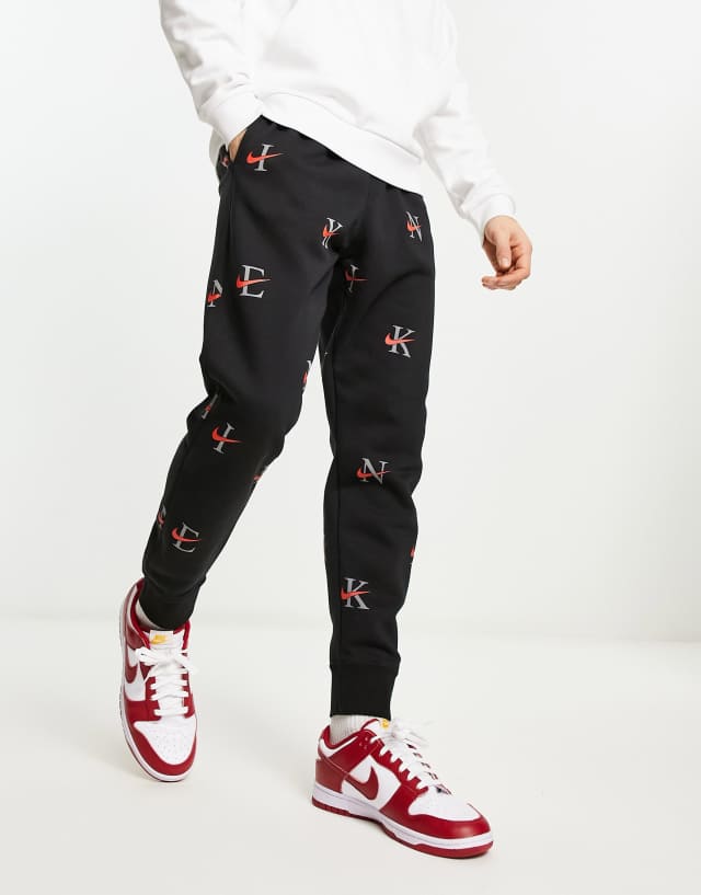 Nike Club Fleece all over print sweatpants in black