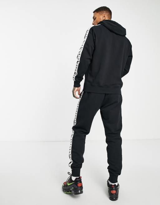 Black nike best sale tracksuit white stripe