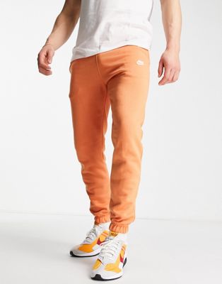 Nike Club loose fit cuffed joggers in orange - ASOS Price Checker