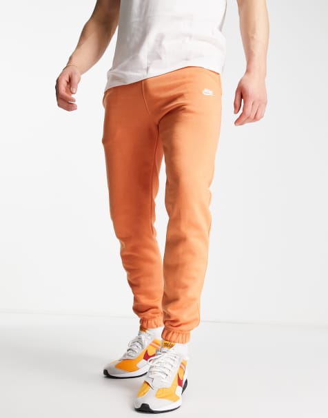 Nike Club loose fit cuffed joggers in orange