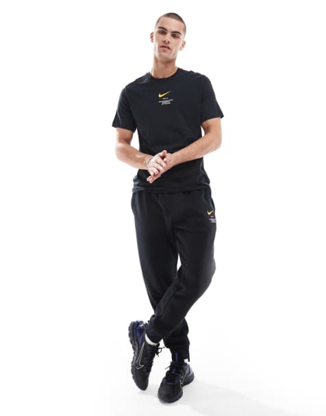 Nike - Club - Pantalon de jogging à imprimé virgule - Noir et jaune - view 1