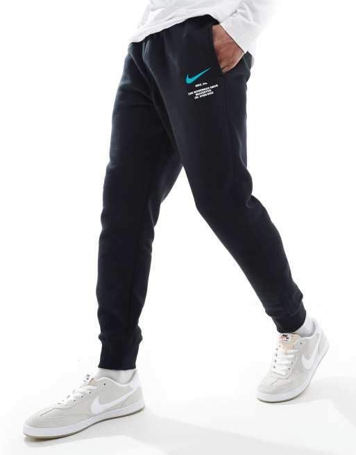 Nike Club Swoosh graphic joggers in black and blue