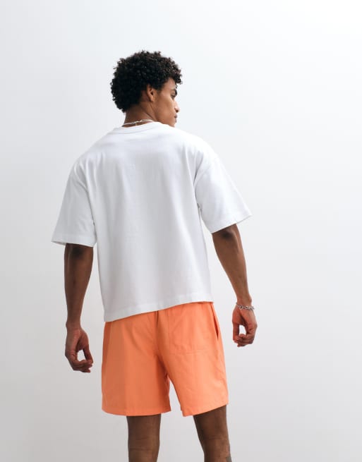 Nike Club Woven shorts in orange | ASOS
