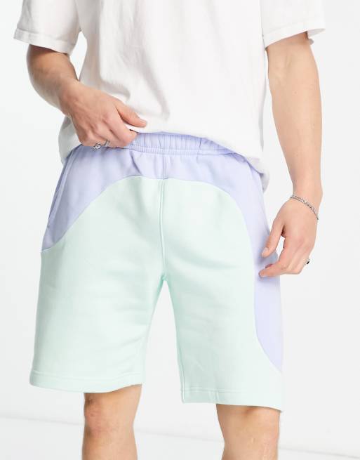 Nike Color Clash color block shorts in pale blue