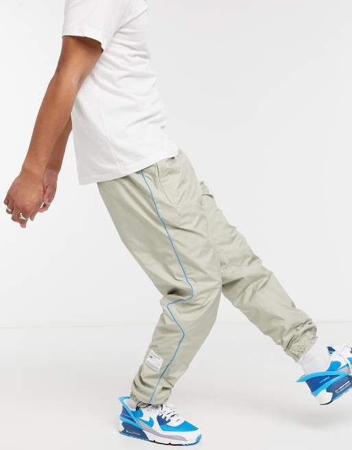 Nike Concrete Jungle Pack woven cuffed joggers in stone